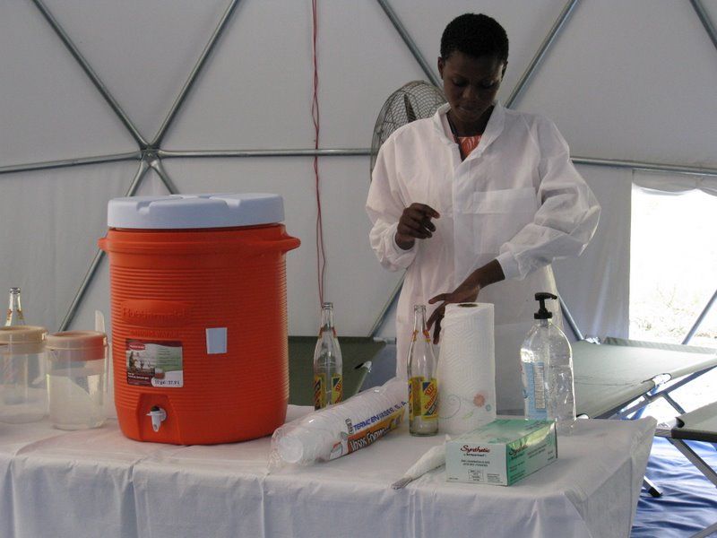 GHESKIO staff member monitoring a chlorination station for disinfection of drinking water during an outbreak of cholera in the aftermath of the 2010 earthquake