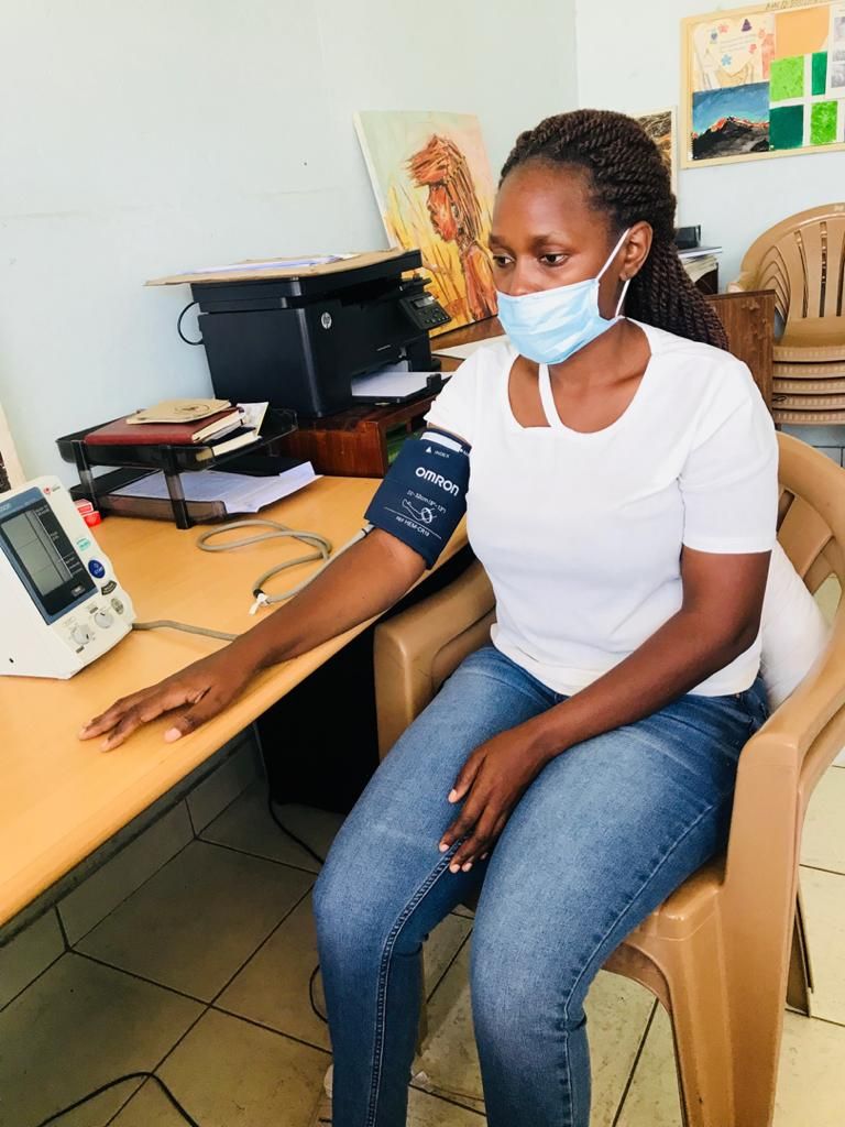 A staff member at one of our clinical sites in Mwanza, Tanzania exhibits how to properly use a blood pressure cuff during a demonstration.